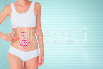 Composite image of attractive woman pointing her belly
