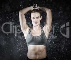 Composite image of muscular woman lifting heavy dumbbells