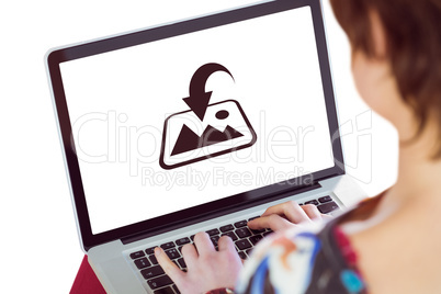 Composite image of cropped image of woman using laptop