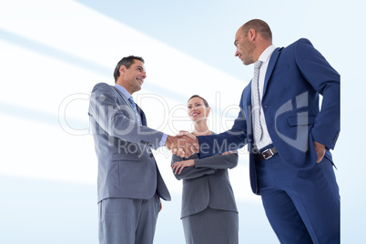 Composite image of business colleagues greeting each other