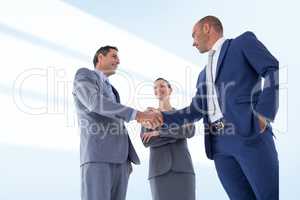 Composite image of business colleagues greeting each other