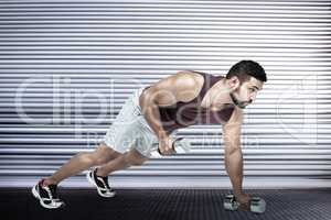 Composite image of muscular man doing push ups with dumbbells