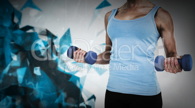 Composite image of muscular woman exercising with dumbbells