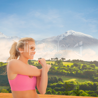 Composite image of smiling toned woman exercising on beach