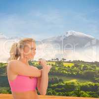 Composite image of smiling toned woman exercising on beach