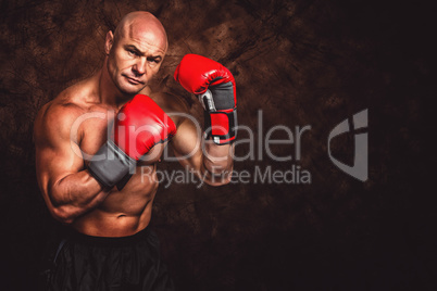 Composite image of portrait of boxer with red gloves