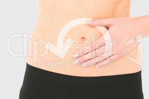 Composite image of closeup mid section of a fit woman with stoma