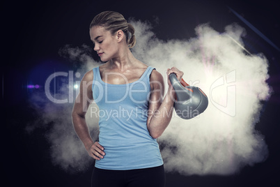 Composite image of muscular woman exercising with dumbbells