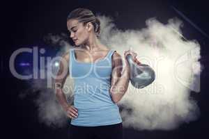 Composite image of muscular woman exercising with dumbbells