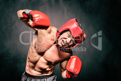 Composite image of aggressive boxer against black background