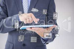 Composite image of businessman using tablet pc