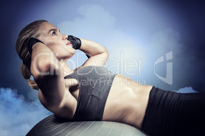 Composite image of muscular woman doing sit ups