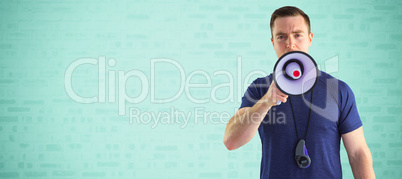 Composite image of male trainer yelling through the megaphone