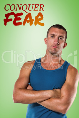 Composite image of serious athlete with arms crossed