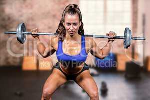 Composite image of portrait confident of woman lifting crossfit
