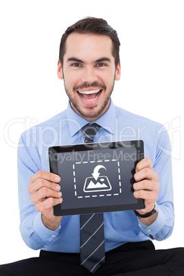 Composite image of happy businessman showing his tablet pc