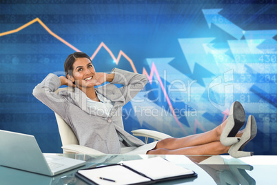 Composite image of businesswoman relaxing in a swivel chair