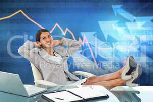 Composite image of businesswoman relaxing in a swivel chair