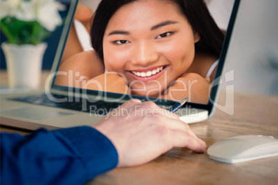 Composite image of businessman using laptop in office