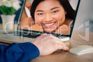 Composite image of businessman using laptop in office