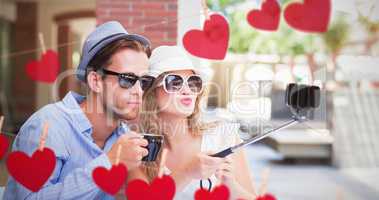 Composite image of cute couple taking a selfie with selfie stick