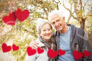 Composite image of senior couple in the park