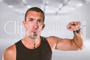 Composite image of portrait of attentive trainer blowing his whi
