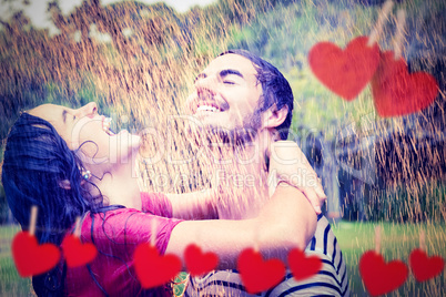 Composite image of cute couple hugging under the rain