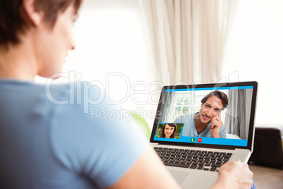 Composite image of pregnant woman using her laptop