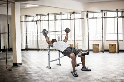 Composite image of fit man exercising with barbell