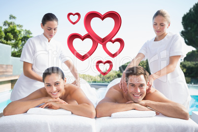 Composite image of smiling couple enjoying couples massage pools