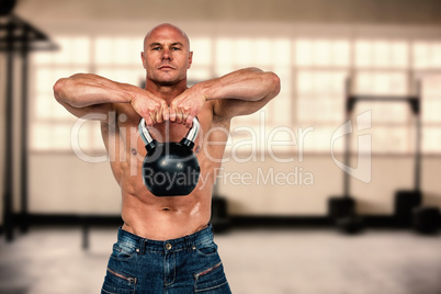 Composite image of portrait of bald man exercising with kettlebe