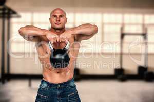 Composite image of portrait of bald man exercising with kettlebe