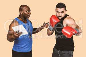 Composite image of boxing coach with his fighter