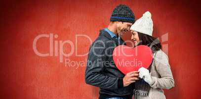 Composite image of festive couple in winter clothes