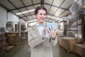 Composite image of smiling businesswoman using tablet computer