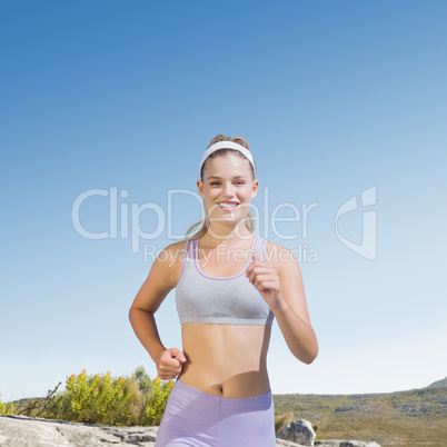 Composite image of sporty happy blonde jogging