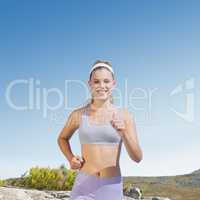 Composite image of sporty happy blonde jogging