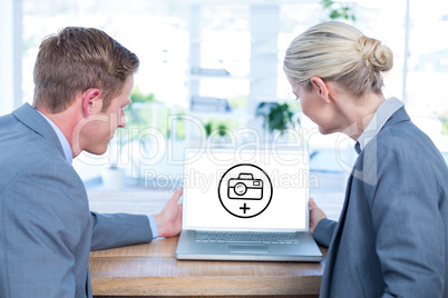 Composite image of business people looking at blank screen of la