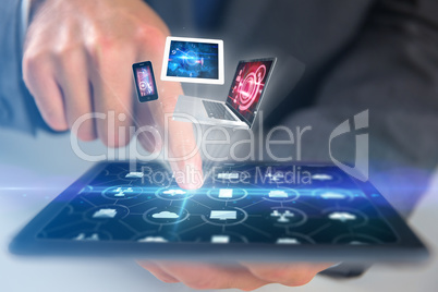 Composite image of businessman using digital tablet