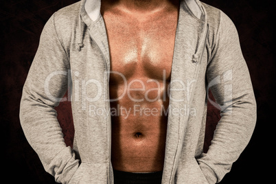 Composite image of muscular man in hooded jumper