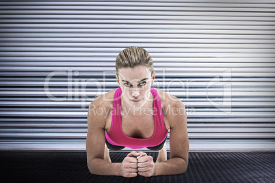 Composite image of  a muscular woman on a plank position