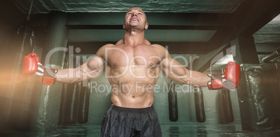 Composite image of boxer with arms outstretched