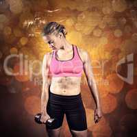 Composite image of muscular woman lifting heavy dumbbell