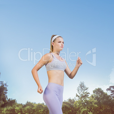 Composite image of sporty focused blonde jogging