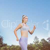 Composite image of sporty focused blonde jogging