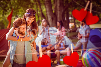 Composite image of hipster couple having fun on campsite