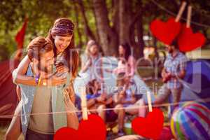 Composite image of hipster couple having fun on campsite