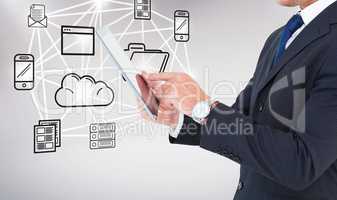 Composite image of businessman in suit using digital tablet