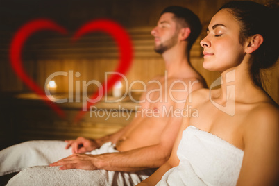 Composite image of happy couple enjoying the sauna together